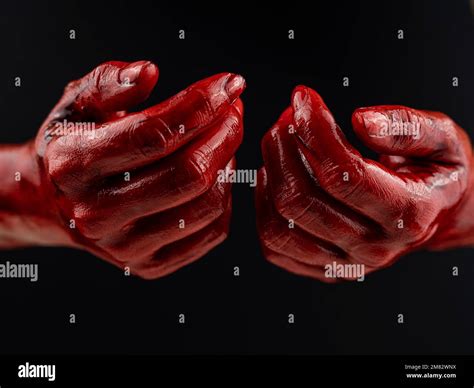Women's hands in blood on a black background Stock Photo - Alamy