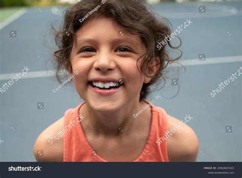 Young Hispanic Girl Laughing While Playing Stock Photo 2452647223 | Shutterstock
