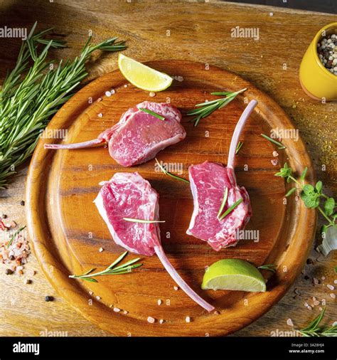 Raw fresh lamb chops Wooden chopping board Stock Photo - Alamy