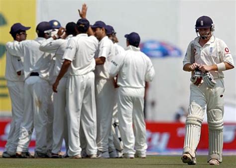 Indian players go into a celebratory huddle as Ian Bell walks back ...