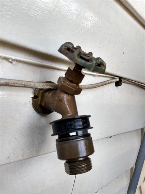 Outdoor spigot attachment that prevents water from flowing down to a ...