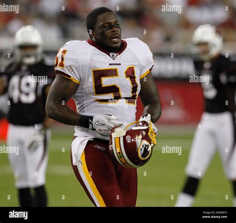 Washington Redskins linebacker Robert Henson (51) puts on his helmet ...