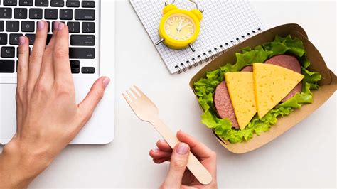busy-woman-eating-meal-on-work-table