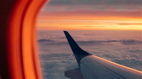 Download wallpaper 2560x1440 airplane, porthole, wing, sunset, clouds ...