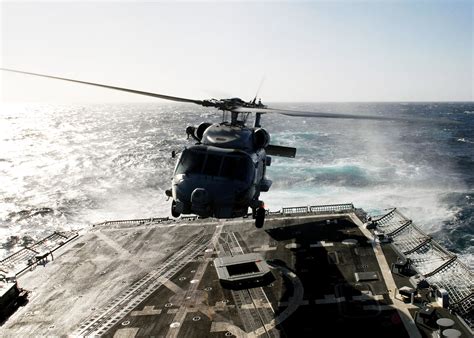 Pilots hover in an SH-60B Seahawk assigned to the "Wolfpack" of ...
