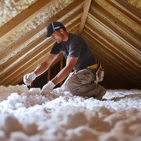 Technician applying blow‑in insulation
