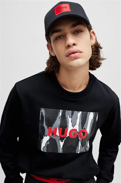 HUGO - Cotton-terry sweatshirt with seasonal logo artwork - Black