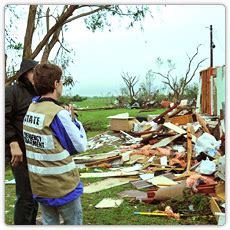 Disaster officials with a homeowner in Oklahoma