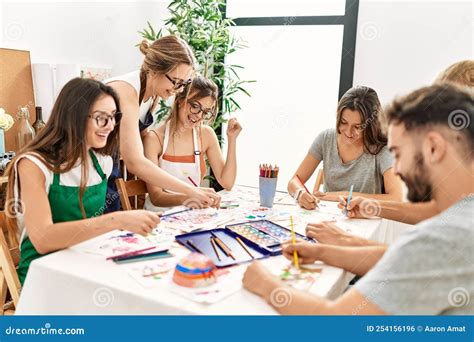 Group of Young Paint Students Smiling Happy and Drawing Sitting on the ...