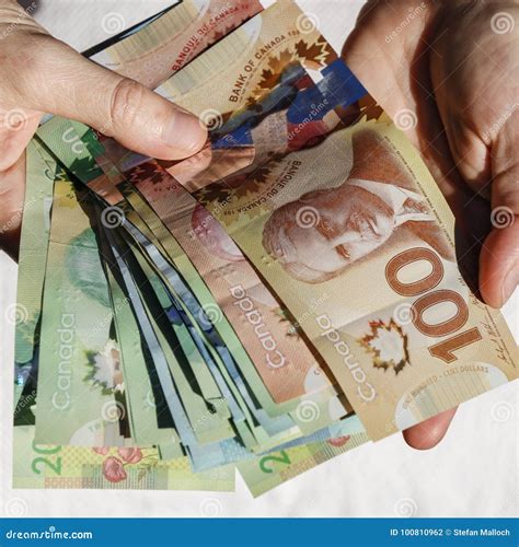 Hands Holding Canadian Cash Editorial Photography - Image of coin, bank: 100810962