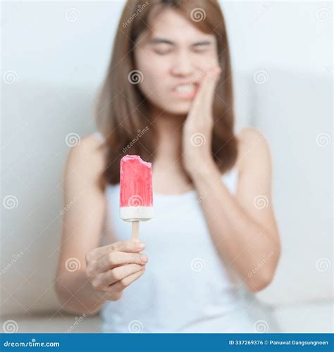 Teeth Sensitive To Cold Concept. Woman Hold Ice Cream And Having ...