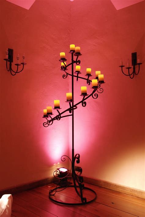 Spiral floor-standing candelabra with battery pillar candles and wall ...