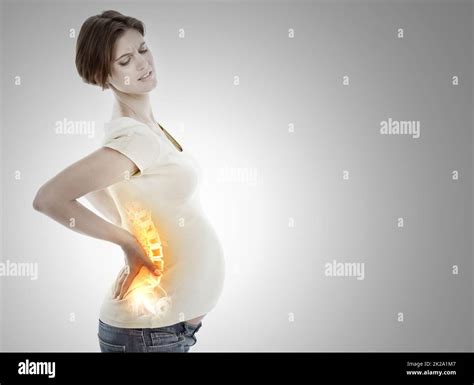 Facing the discomfort of pregnancy. A cropped view of a pregnant woman ...