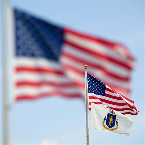 a smaller massachusetts state flag and the u s flag are placed side by ...