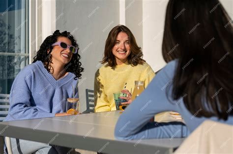 Premium Photo | Medium shot women drinking kombucha