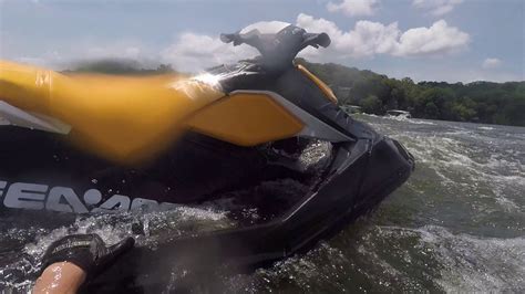 A woman performing a stunt on her Sea-Doo Spark with the words “Make Waves sales event”