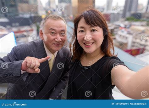 Mature Asian Businessman and Mature Asian Woman Exploring the City ...