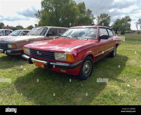 Old red sporty Ford Taunus Cortina TC3 two door fastback coupe SP 1980s in the countryside ...