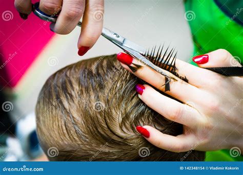 Barber Cutting a Child`s Scissors. Close-up Photo Stock Photo - Image ...