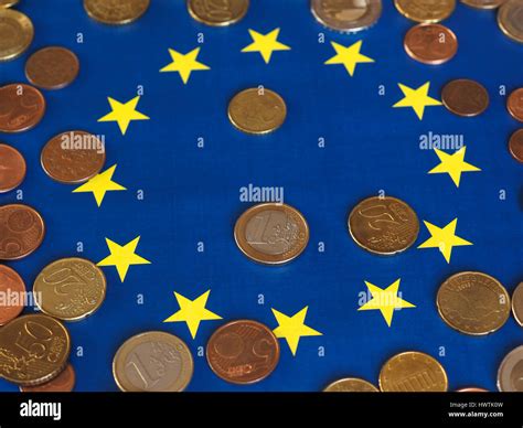 Euro coins (EUR), currency of European Union over flag of Europe Stock Photo - Alamy