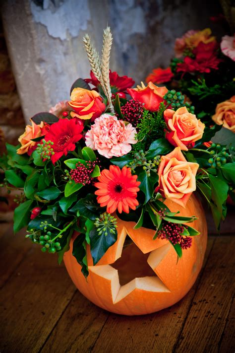 Our table flowers in pumpkins carved with hearts & stars. | Halloween ...