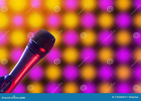 Vocal Microphone on Pink, Purple and Yellow Disco Background Lighting ...