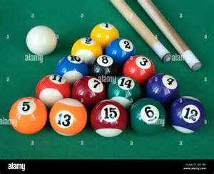 Mini billiards, pool or snooker balls on the green felt. Fourteen ...