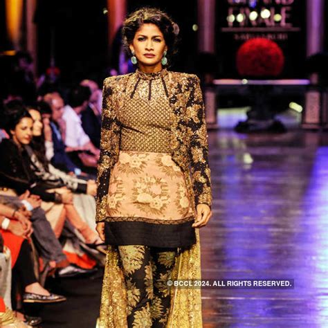 Model Parvathy Omnakuttan (L) walks the ramp for designer Sabyasachi ...