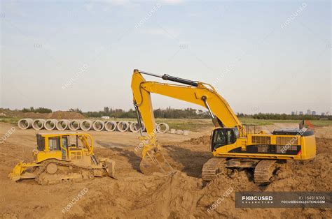 Image result for Backhoe Digging Hole