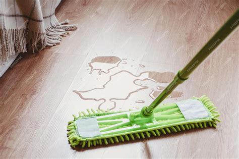 Premium Photo | Water on the laminated wooden floor in bedroom mop ...
