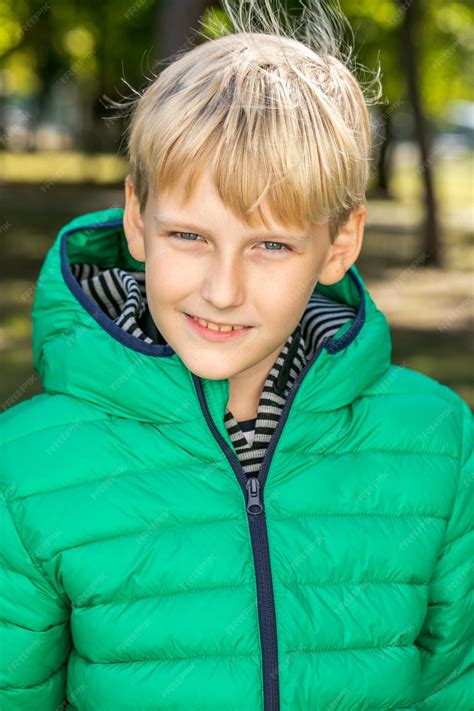 Premium Photo | Ten year old boy in autumn green jacket in autumn park