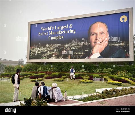 Villagers sit in the lawns outside the Jamnagar Refinery run by the Indian business conglomerate ...