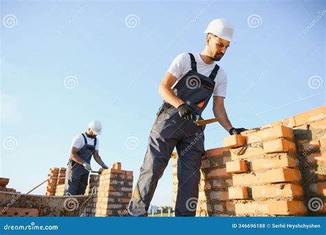 Professional Construction Workers Build a Brick House. Industrial Theme ...