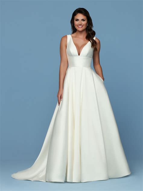 This simple mikado gown has a deep v-neckline with a detachable modesty ...