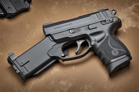 Compact carry pistol with ambidextrous controls and extended slide ...