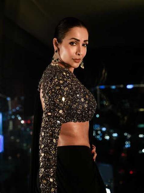 Photos: Malaika Arora strikes a killer pose in a black shimmering sari.