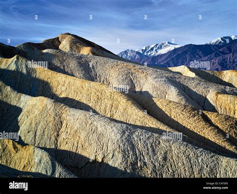 Rock formations and snow covered Telescope Peak from Golden Canyon ...