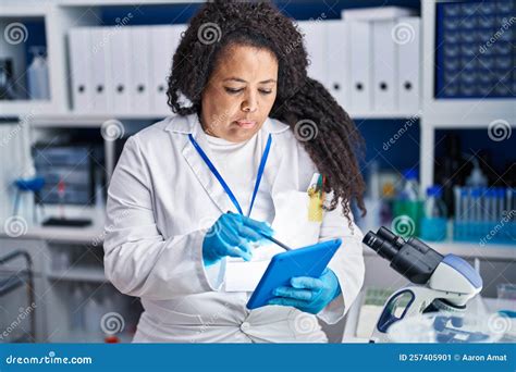 African American Woman Scientist Writing on Touchpad at Laboratory ...