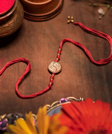 Hand crafted dokhra rakhi with red mercerised cotton thread – GoSwadeshi