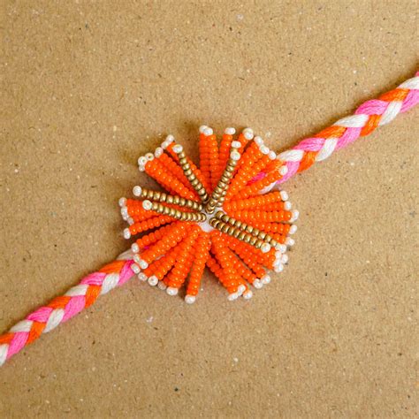 Buy Reusable Beaded Orange Flower Rakhi With Roli Chawal Online On Zwende