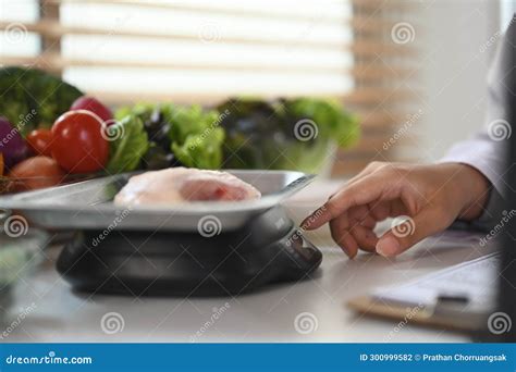 Nutritionist Weighing Raw Chicken Breast on a Scale during Consultation ...