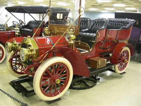 an old fashioned car is on display in a museum