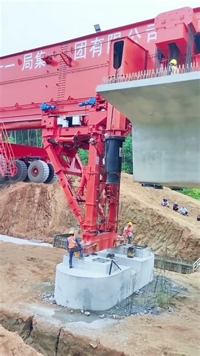 Spectacular infrastructure site as huge machine lifts full‑span bridge girders