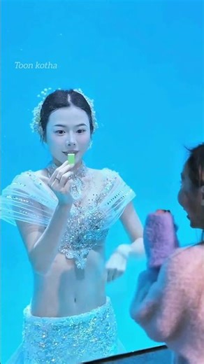 This girl is a mermaid in this aquarium.