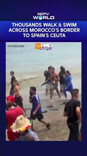 Dramatic Visuals Show Thousands Walking & Swimming Across Morocco's Border to Spain's Ceuta