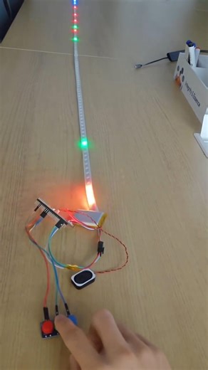 DIY electronics project in action, featuring a long addressable LED strip stretched across