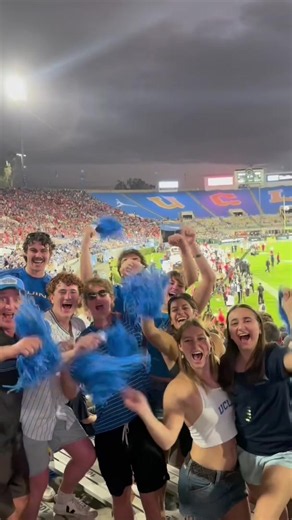What a time to be a Bruin. 💙💛 [Video description: A montage of clips shows UCLA football players on the field, fans cheering and waving blue pom-poms in the stands, and musicians and performers throughout a crowded stadium.]