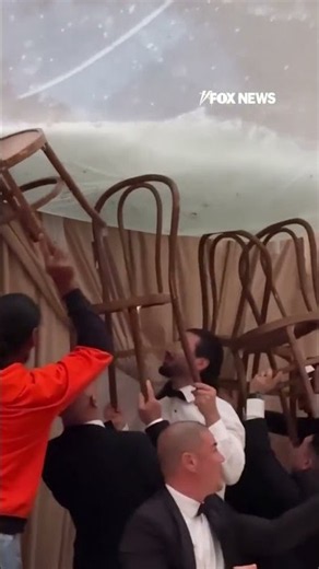 SEE IT: Wedding guests use chais to stop venue from flooding #shorts