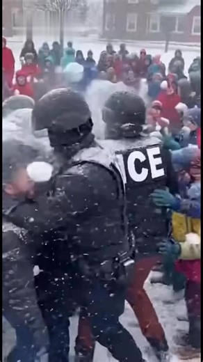 🚨 BREAKING: Shocking ambush in Branson, Missouri amid heavy blizzard conditions. A swarm of over 100 elementary-age children unleashes thousands of densely packed snowballs on a small team of ICE agents—relentless barrage slams helmets, faces, and gear. Agents, clearly marked in tactical vests, are overwhelmed: desperately begging “Stop! Please stop throwing!” and visibly breaking down in tears as voices crack with pleas. Kids show no signs of stopping, continuing the onslaught. Agents stagger 