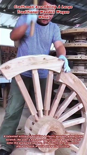 Craftsman Assembling A Large Traditional Wooden Wagon Wheel